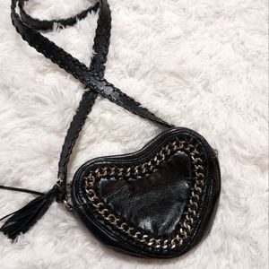 Black heart shape bag purse cross body with gold chain details. Faux leather.